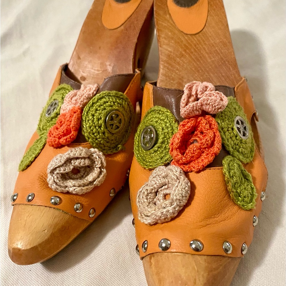 Wooden clogs with colorful crocheted flowers.